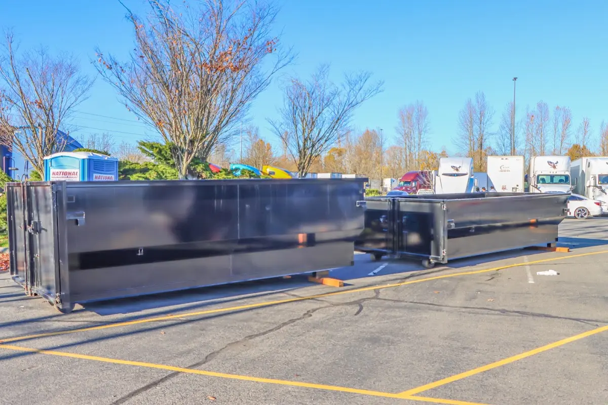 Professional dumpster rental service with roll-off container on residential driveway in Universal City